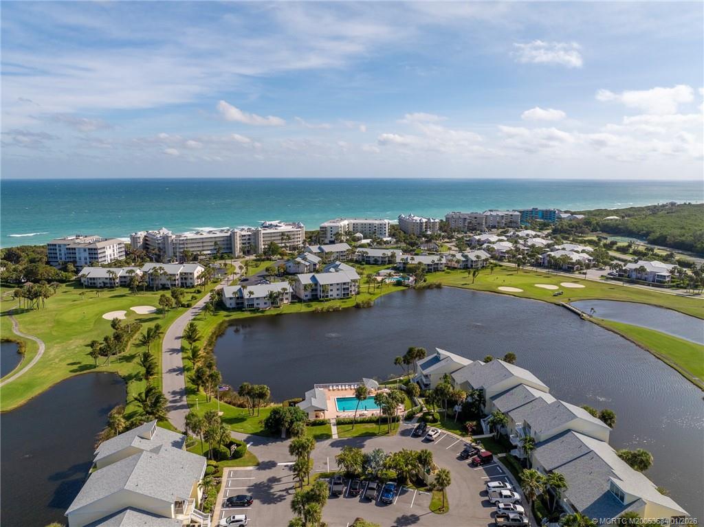 579 Northeast Plantation Road, Unit N202 Jensen Beach, FL 34957 - Photo 22 of 42 an aerial view of ocean and residential houses with outdoor space