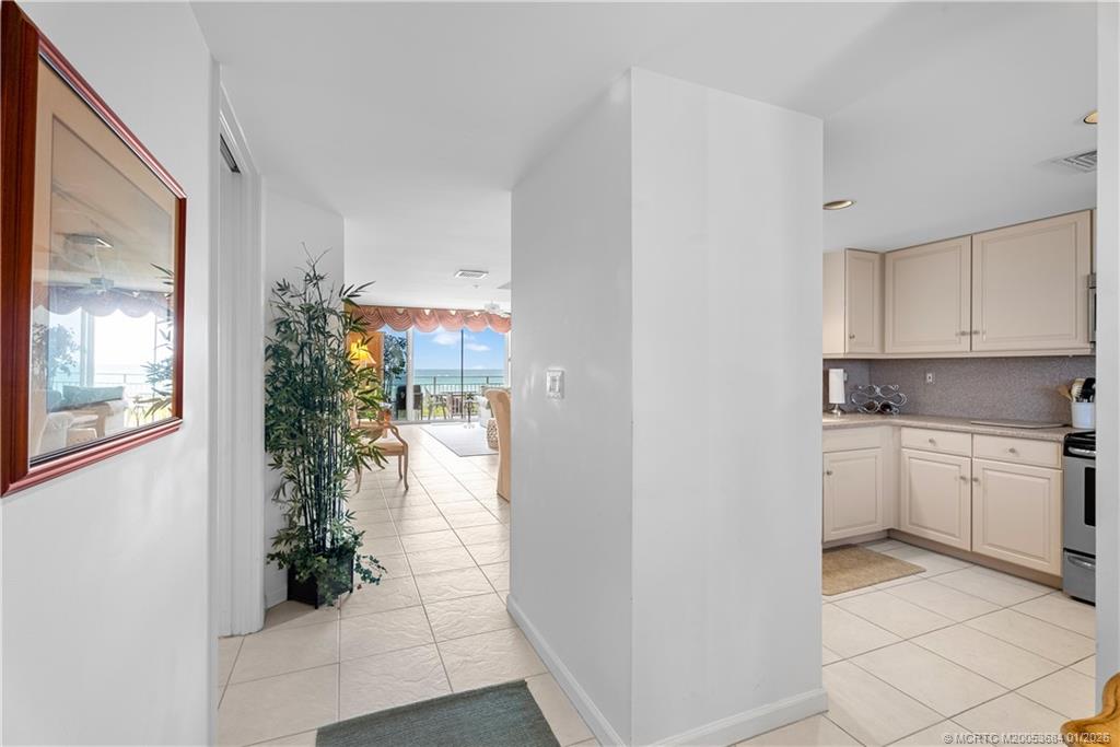 579 Northeast Plantation Road, Unit N202 Jensen Beach, FL 34957 - Photo 25 of 42 a kitchen with a white stove next to a window