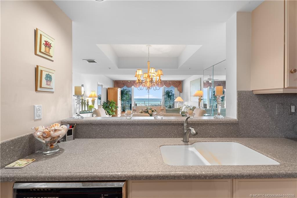 579 Northeast Plantation Road, Unit N202 Jensen Beach, FL 34957 - Photo 28 of 42 a kitchen with a sink and a refrigerator