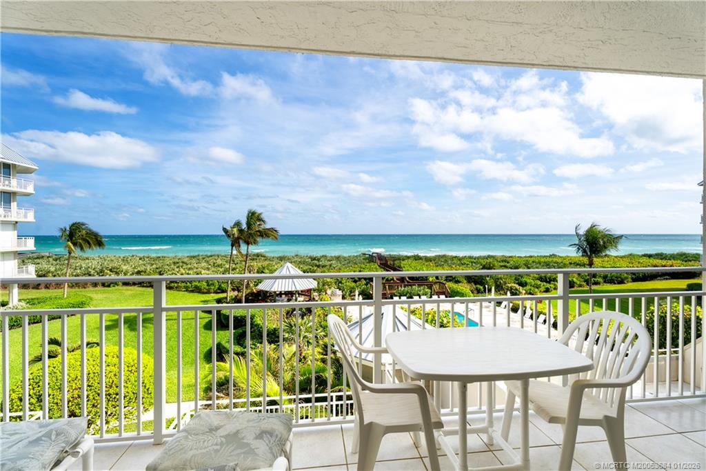 579 Northeast Plantation Road, Unit N202 Jensen Beach, FL 34957 - Photo 38 of 42 a view of an ocean with a table and chairs