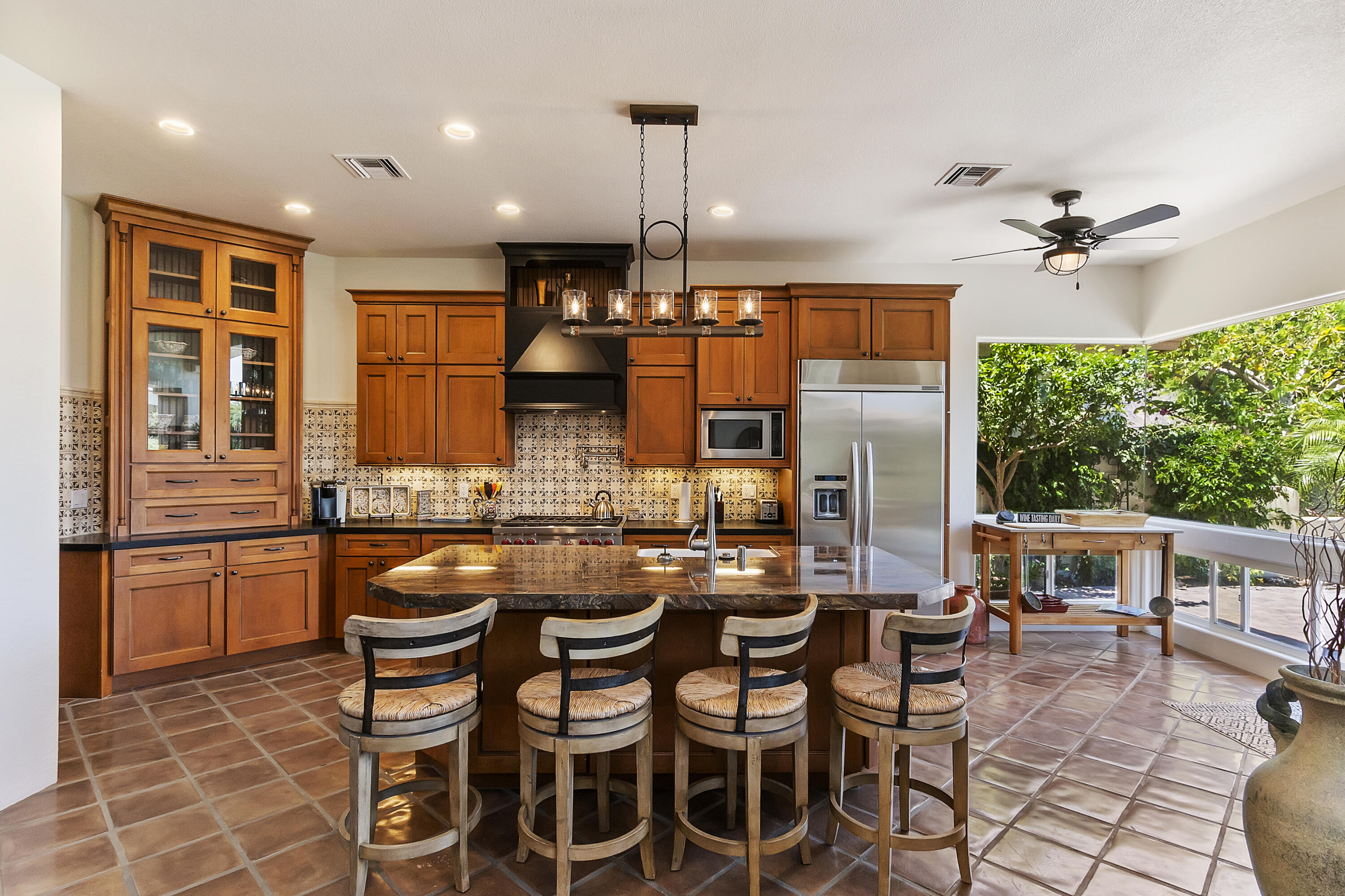 78920 Cabrillo Way La Quinta, CA 92253 - Photo 11 of 41 a dining hall with stainless steel appliances a stove a table and chairs