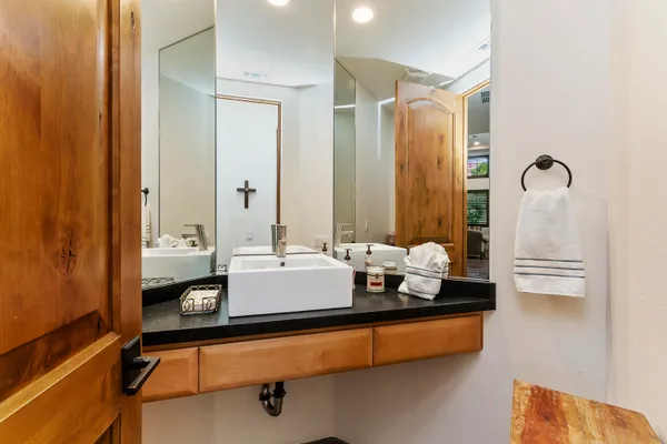 a bathroom with a tub sink and mirror