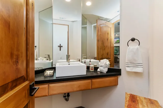 a bathroom with a tub sink and mirror