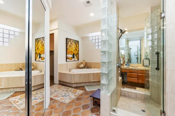 a bathroom with a tub shower and sink