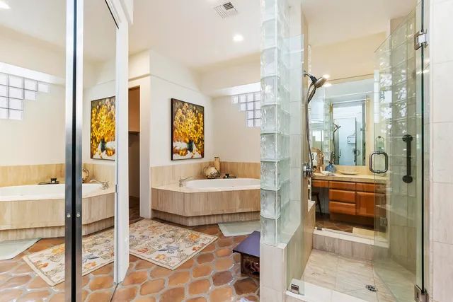 a bathroom with a tub shower and sink