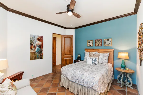 a bedroom with a large bed and a chandelier