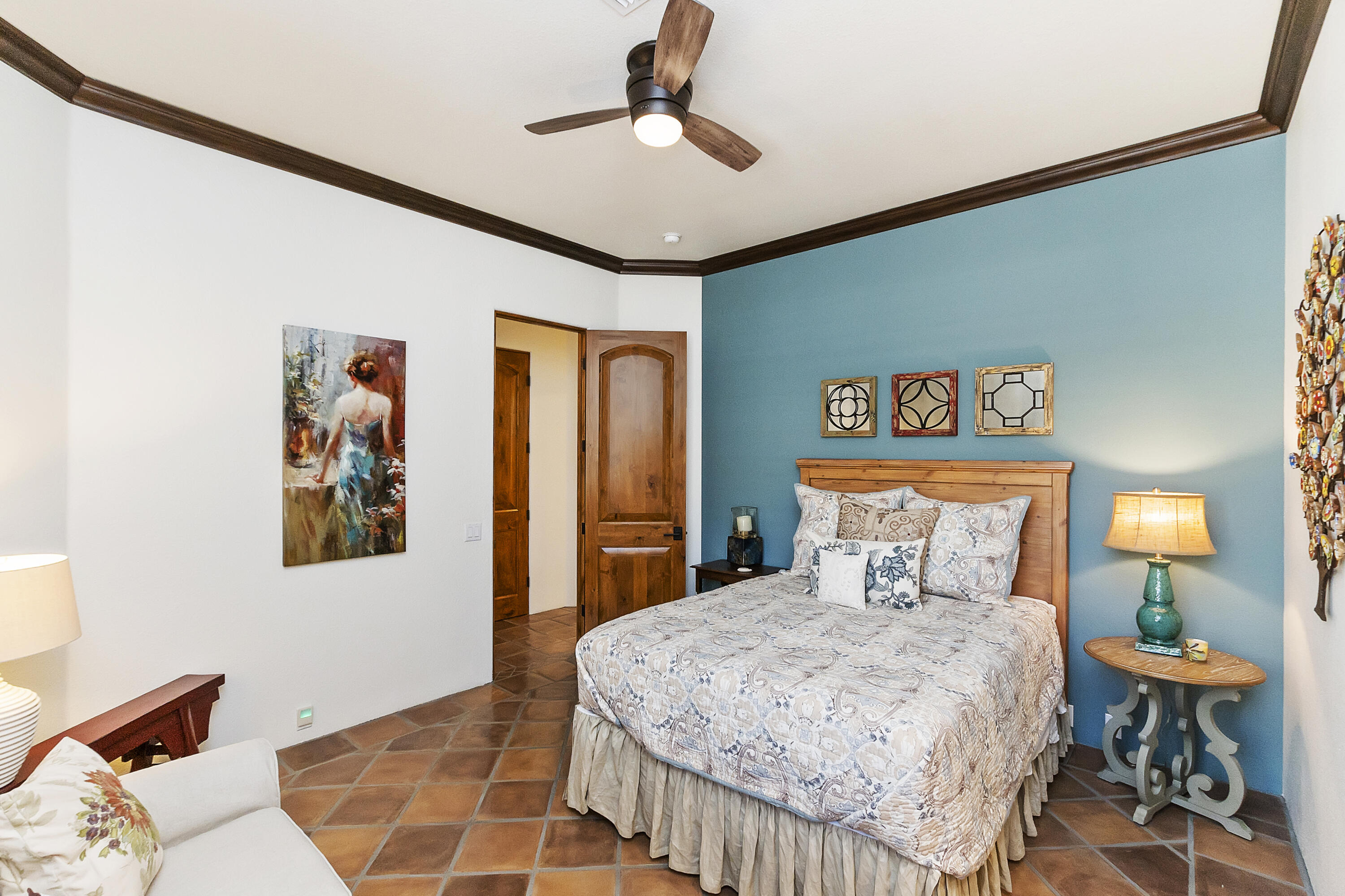 78920 Cabrillo Way La Quinta, CA 92253 - Photo 22 of 41 a bedroom with a large bed and a chandelier