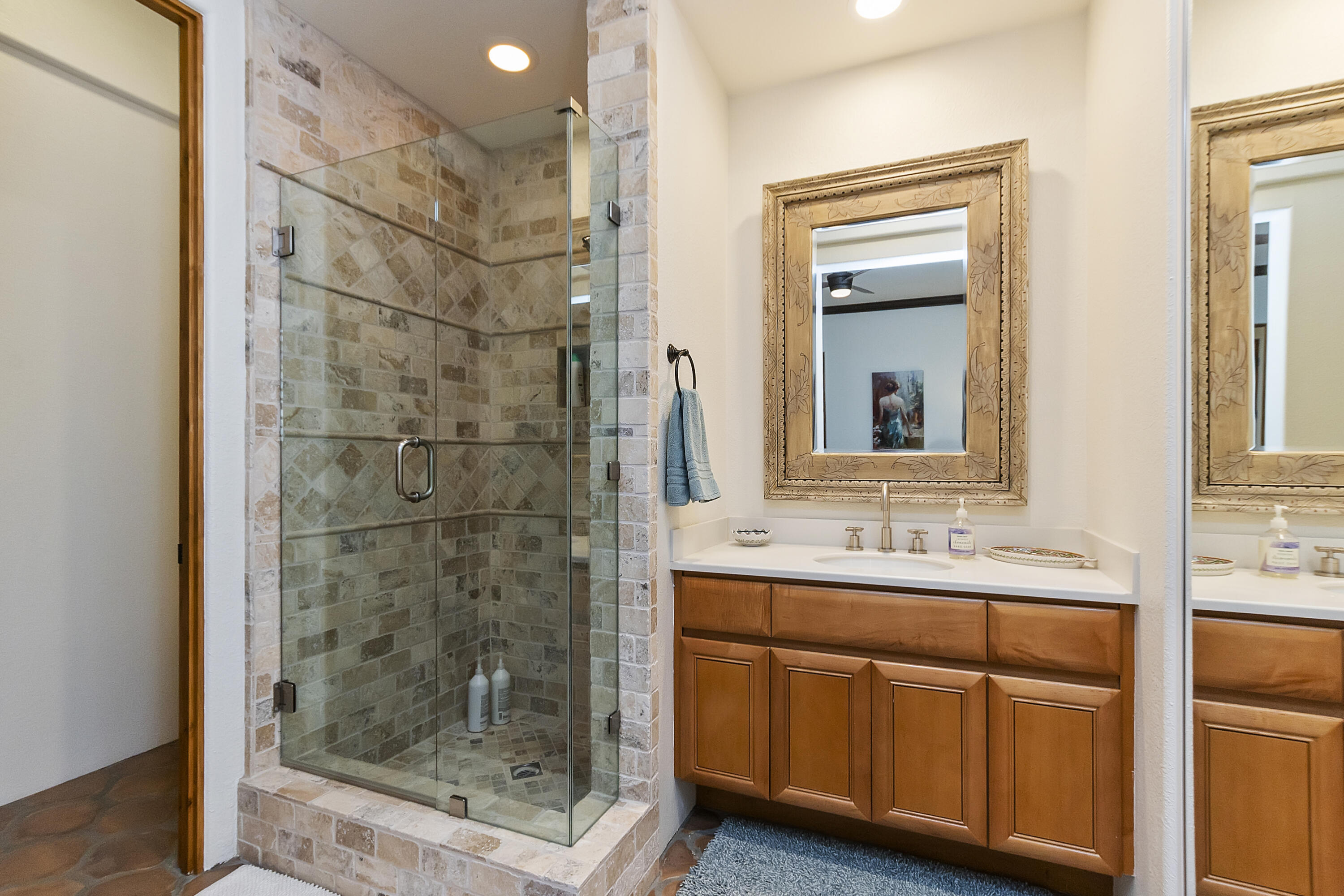 78920 Cabrillo Way La Quinta, CA 92253 - Photo 23 of 41 a bathroom with a granite countertop sink a mirror and shower