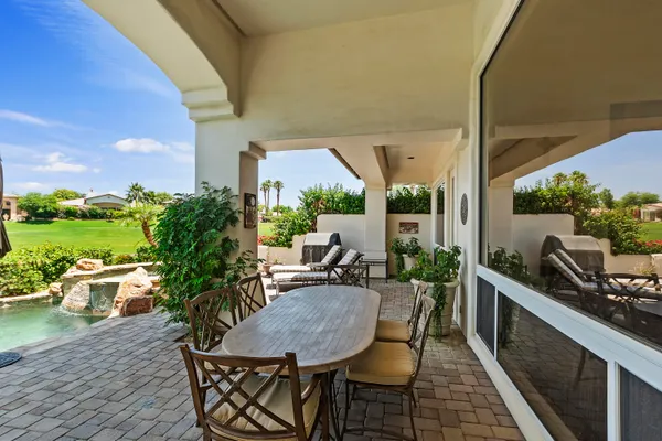 a view of a patio with table and chairs and potted plants