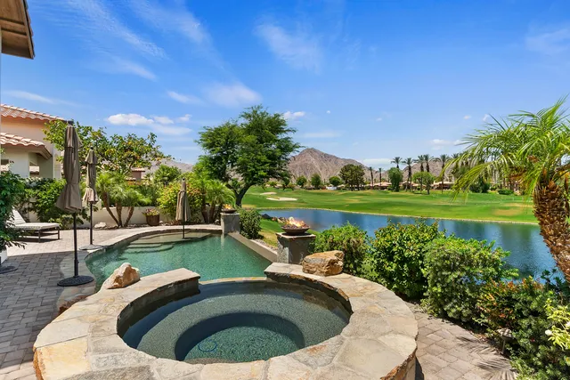a view of a house with a big yard and potted plants