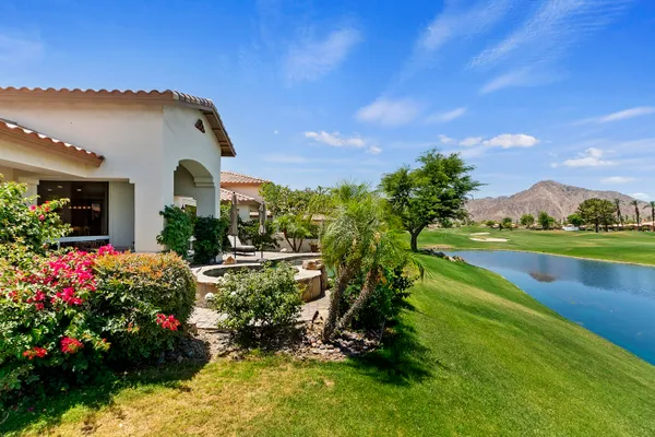 a view of a house with swimming pool and sitting area