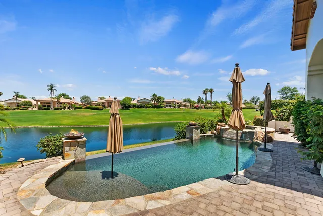 a view of a swimming pool and a yard