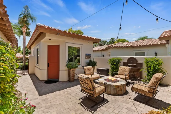 a living room with furniture a flat screen tv and a clock