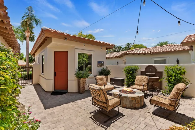 a living room with furniture a flat screen tv and a clock