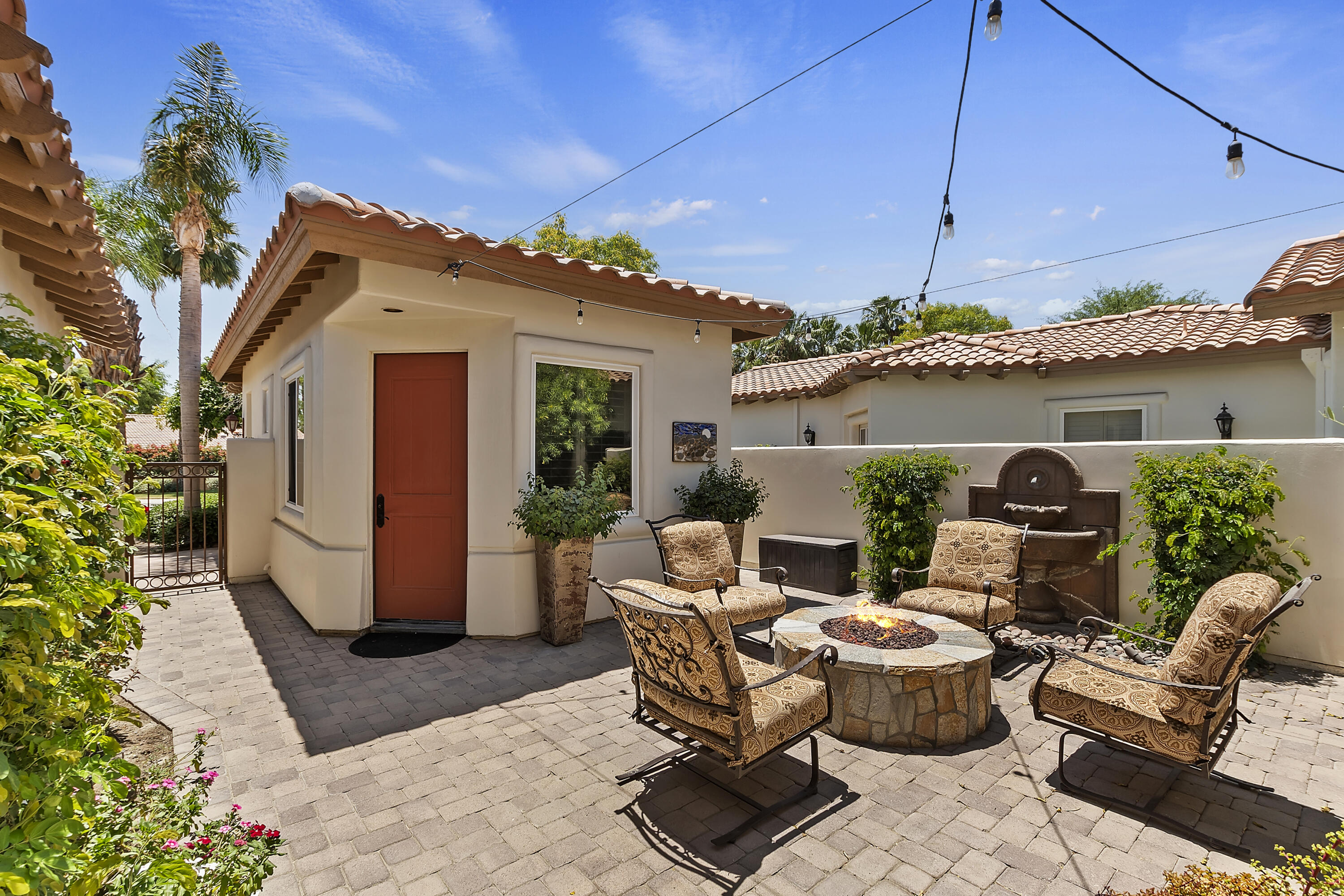 78920 Cabrillo Way La Quinta, CA 92253 - Photo 33 of 41 a view of a patio with couches table and chairs under an umbrella