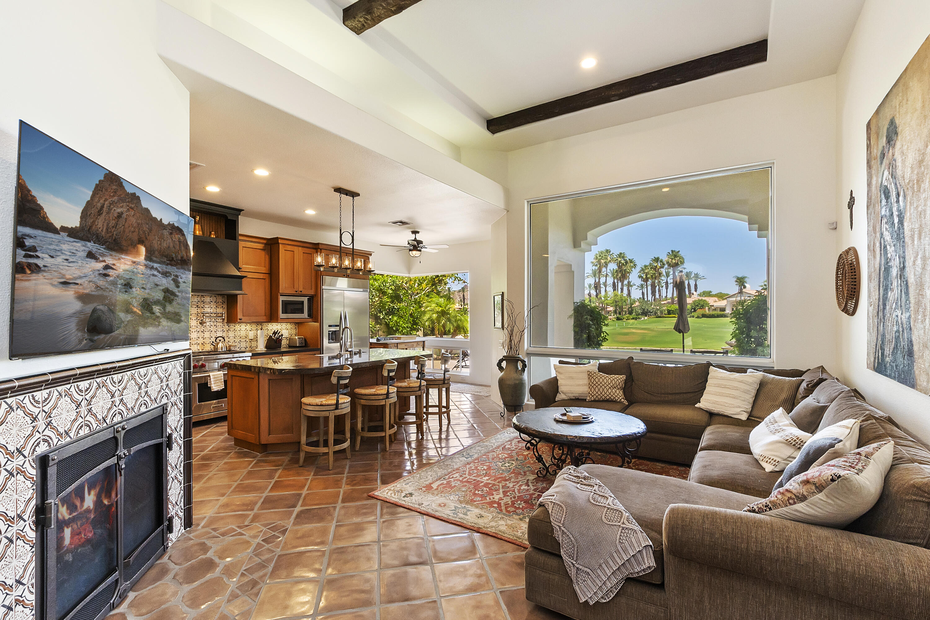 78920 Cabrillo Way La Quinta, CA 92253 - Photo 7 of 41 a living room with furniture a fireplace and a floor to ceiling window