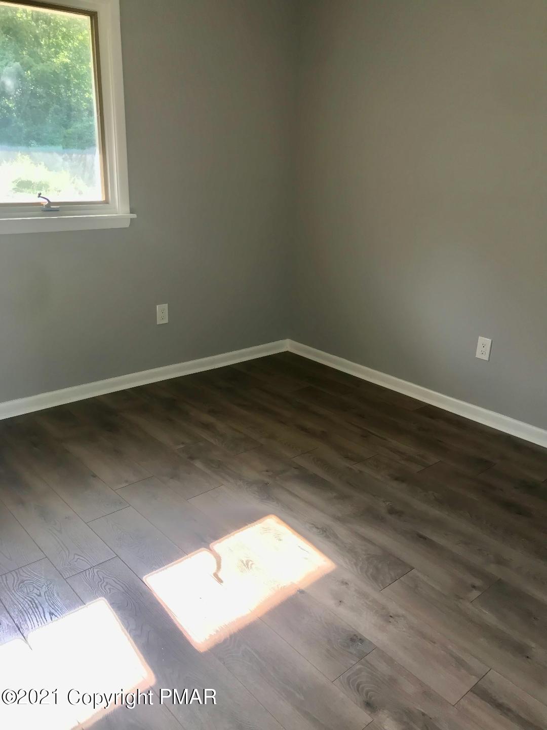 104 Kent Road Stroudsburg, PA 18360 - Photo 15 of 28 an empty room with wooden floor and windows