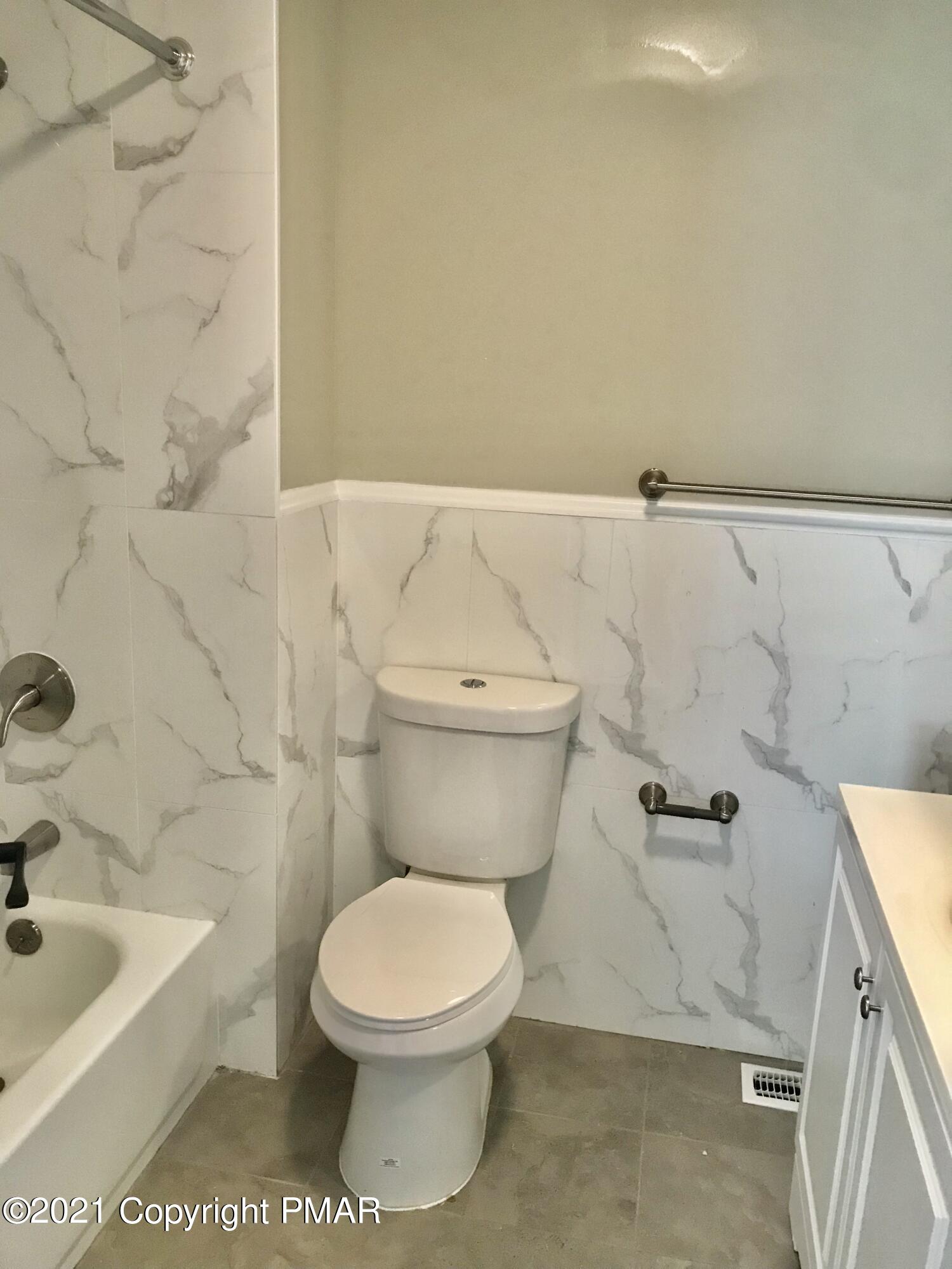 104 Kent Road Stroudsburg, PA 18360 - Photo 18 of 28 a white toilet sitting next to a bath tub