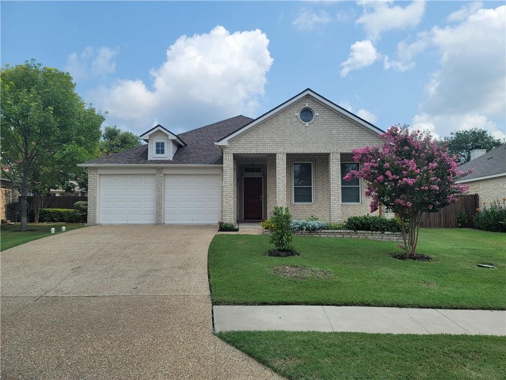 208 Hummingbird Lane Leander, TX 78641 - Photo 1 of 25 A cream brick facade with a prominent driveway offers an inviting curb appeal.