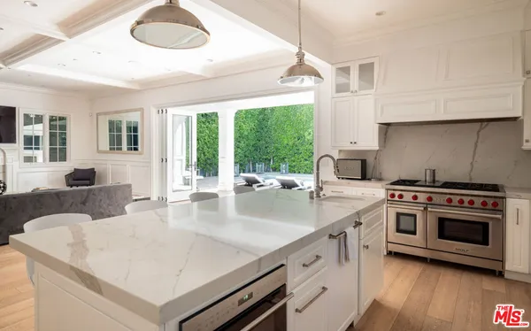 a kitchen with a stove a sink and a refrigerator