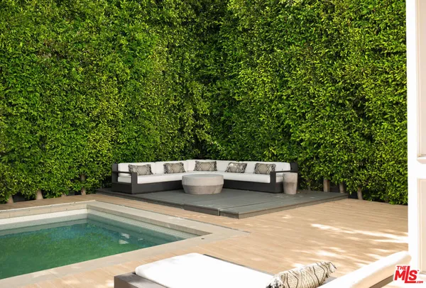 a view of a backyard with sitting area