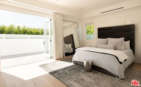 a large white bed in a white room