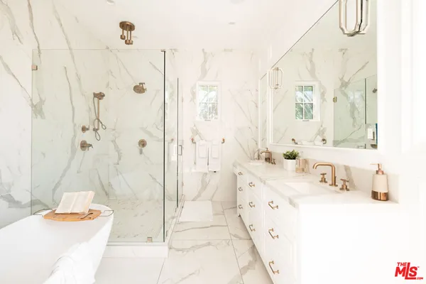 a bath room with a bath tub and shower