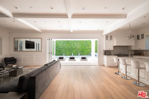 a large white kitchen with a large window