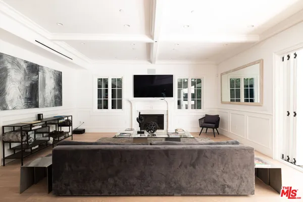 a living room with fireplace furniture and a flat screen tv
