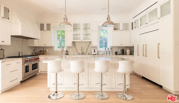 a kitchen with kitchen island granite countertop a table and chairs