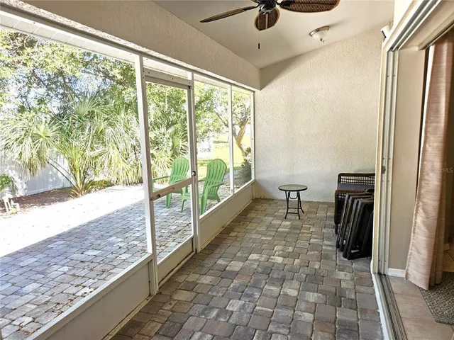 a view of a large room with wooden floor and a bed