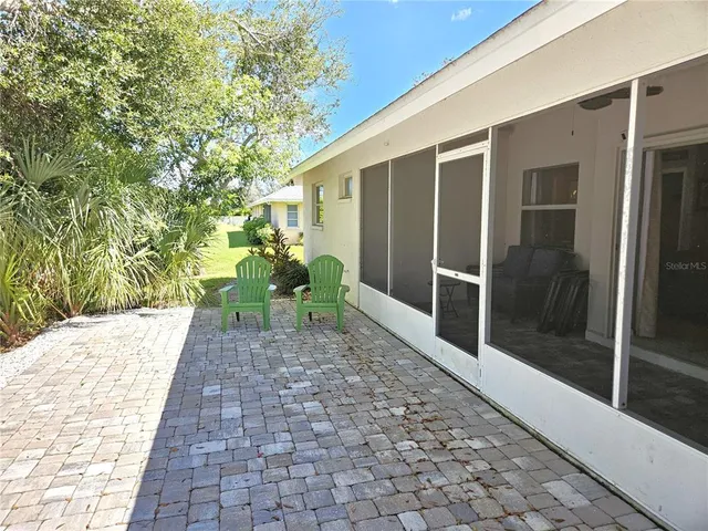 a view of a back yard with patio