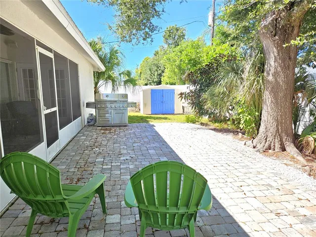 a view of a backyard with plants and a patio