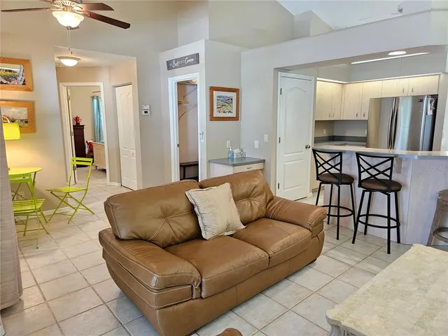a living room with furniture wooden floor and a view of kitchen
