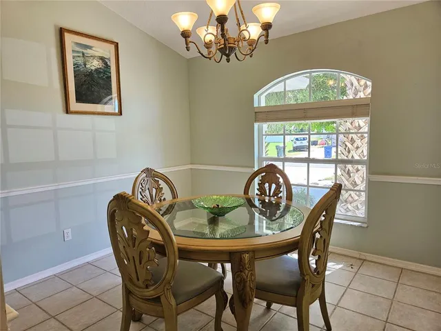 a dining room with furniture a livingroom and a chandelier