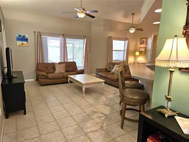 a living room with furniture a lamp and a window