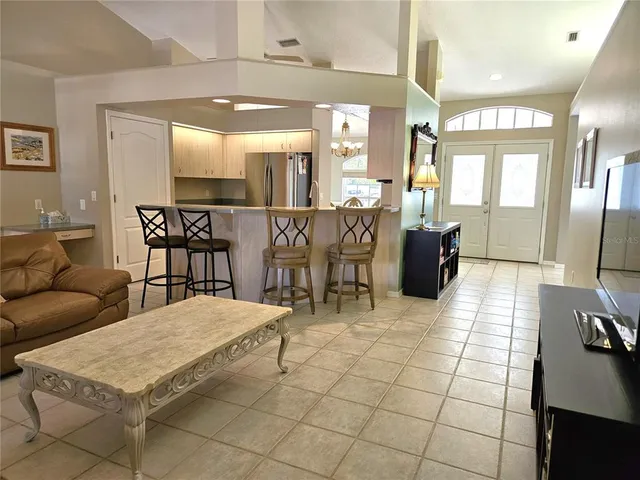 a living room with a table and chairs in it