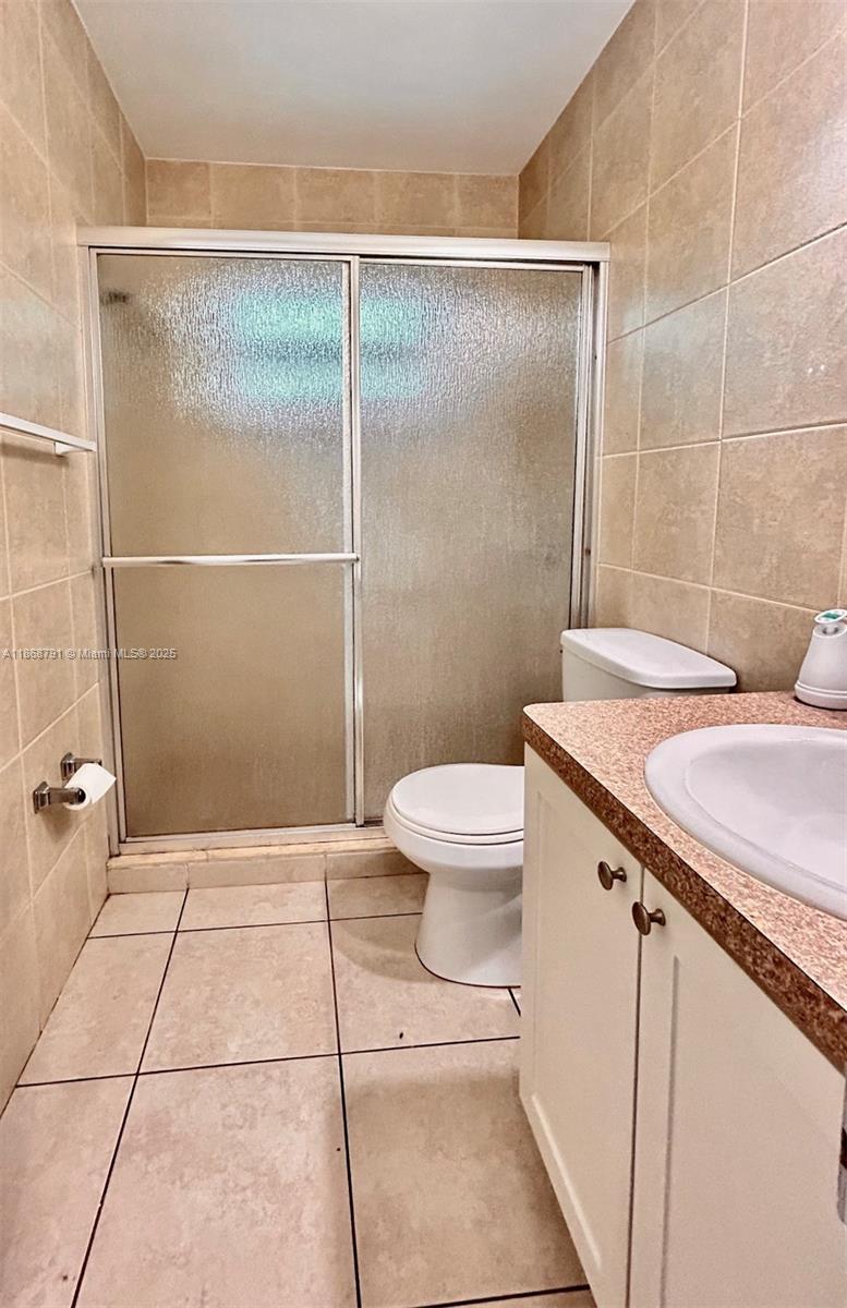 3265 Griffin Road, Unit 205 Dania Beach, FL 33312 - Photo 11 of 13 a bathroom with a granite countertop sink toilet and shower