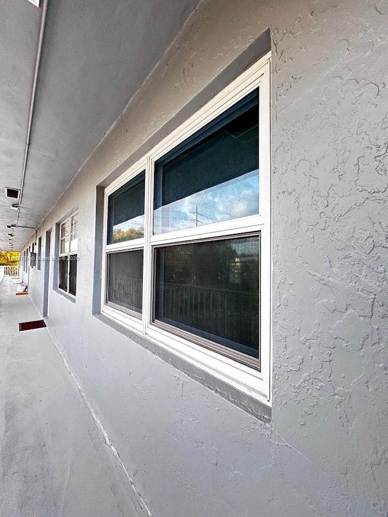 3265 Griffin Road, Unit 205 Dania Beach, FL 33312 - Photo 2 of 13 a view of a hallway with a fireplace