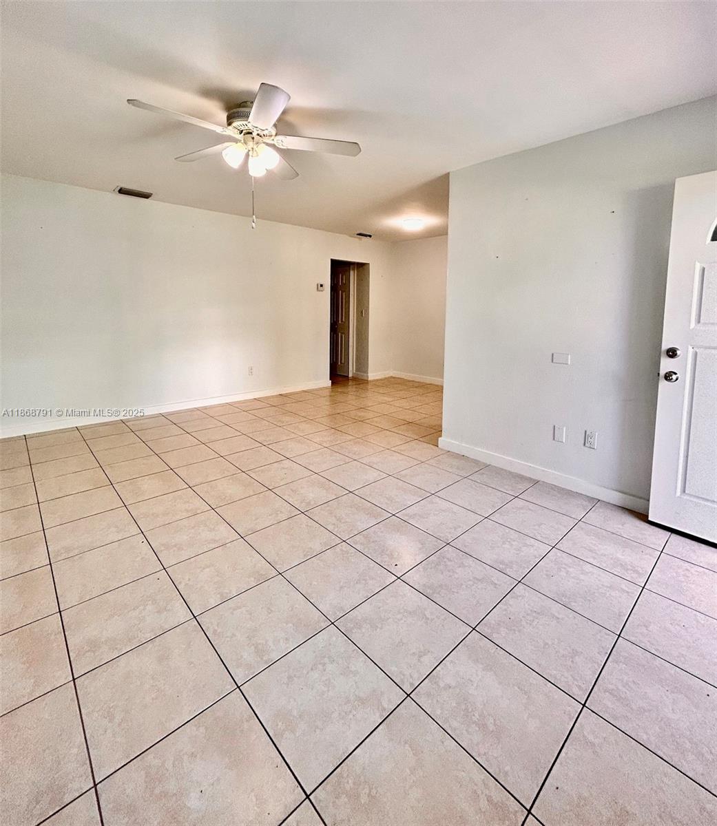 3265 Griffin Road, Unit 205 Dania Beach, FL 33312 - Photo 4 of 13 a view of an empty room and chandelier fan