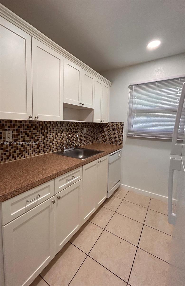 3265 Griffin Road, Unit 205 Dania Beach, FL 33312 - Photo 6 of 13 a kitchen with cabinets and window