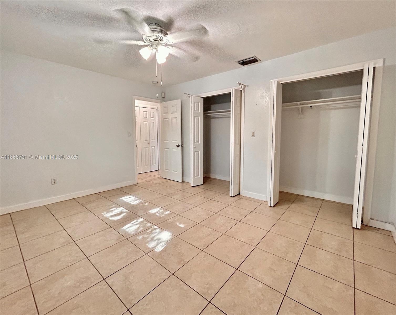 3265 Griffin Road, Unit 205 Dania Beach, FL 33312 - Photo 10 of 13 a view of an empty room and chandelier fan
