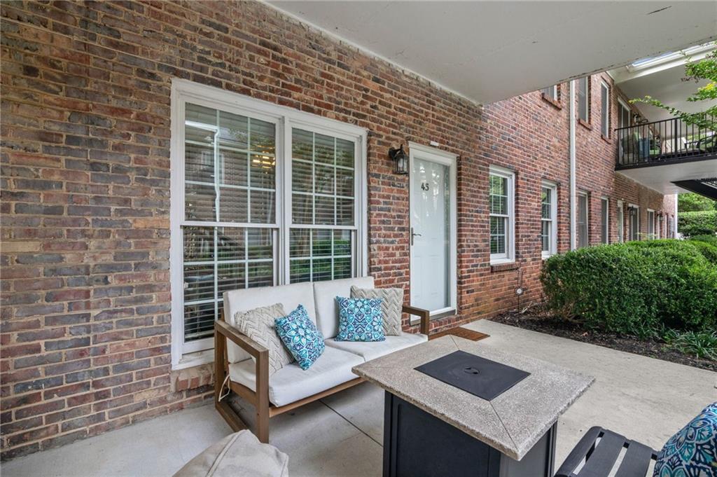 3675 Peachtree Road Northeast, Unit 45 Atlanta, GA 30319 - Photo 2 of 42 a view of a patio with couches and a potted plant on a table