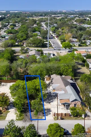 an aerial view of residential houses with outdoor space and street view