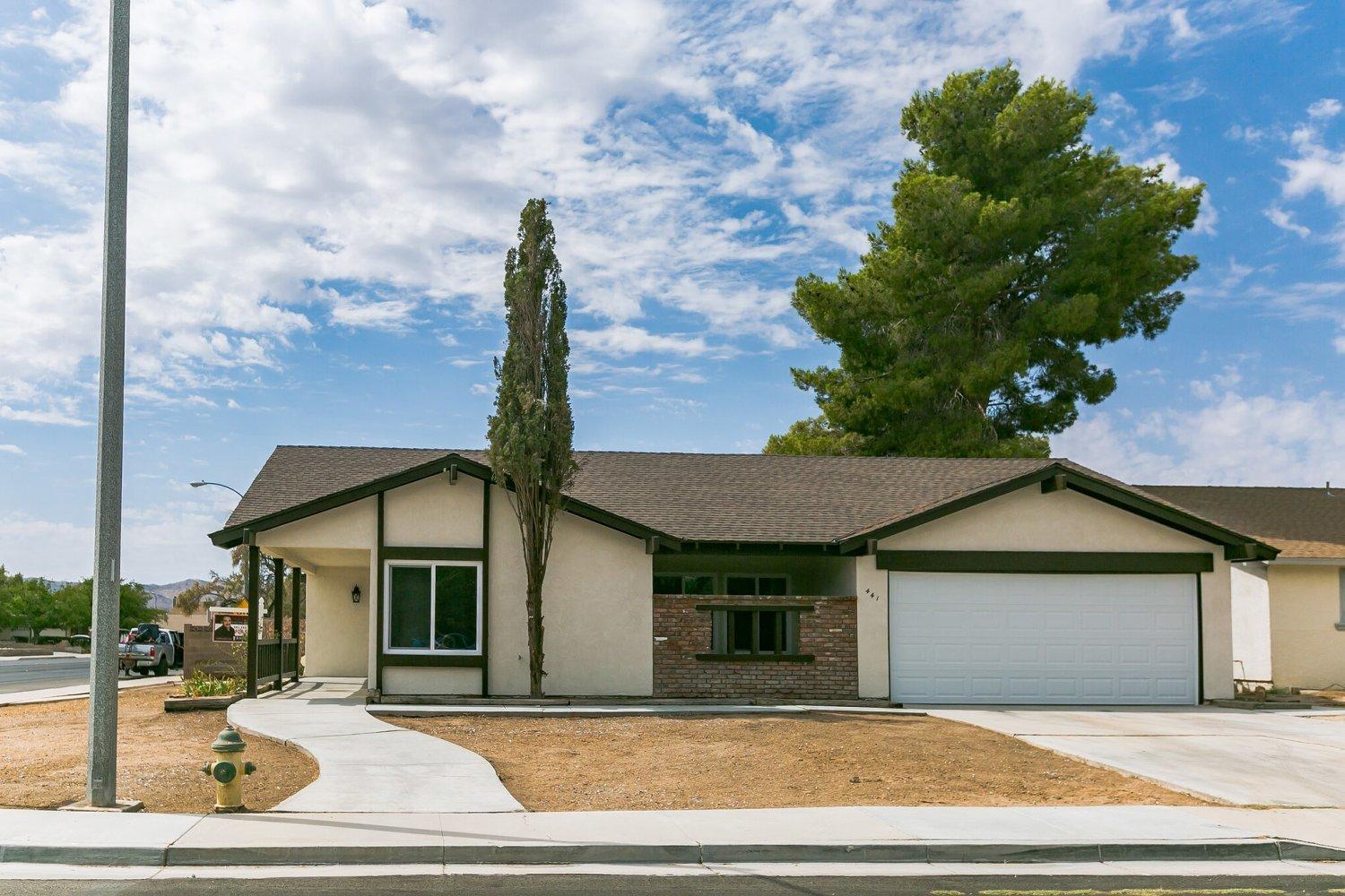 441 Debra Lane Ridgecrest, CA 93555 - Photo 1 of 30 a front view of a house with a yard and garage