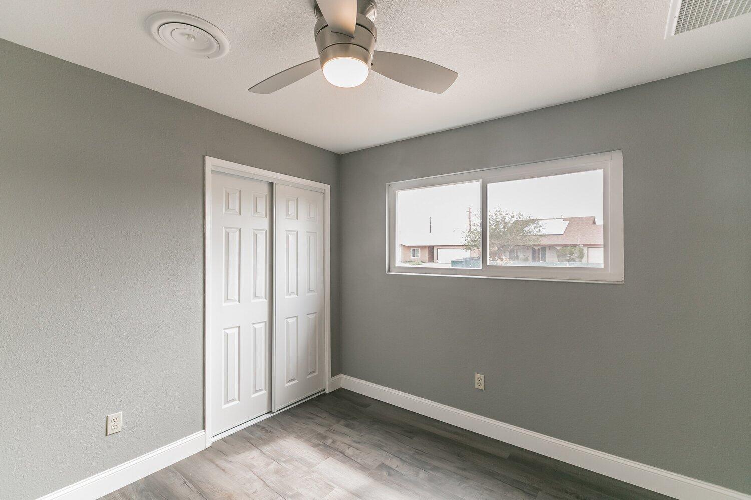 441 Debra Lane Ridgecrest, CA 93555 - Photo 15 of 30 an empty room with windows and fan
