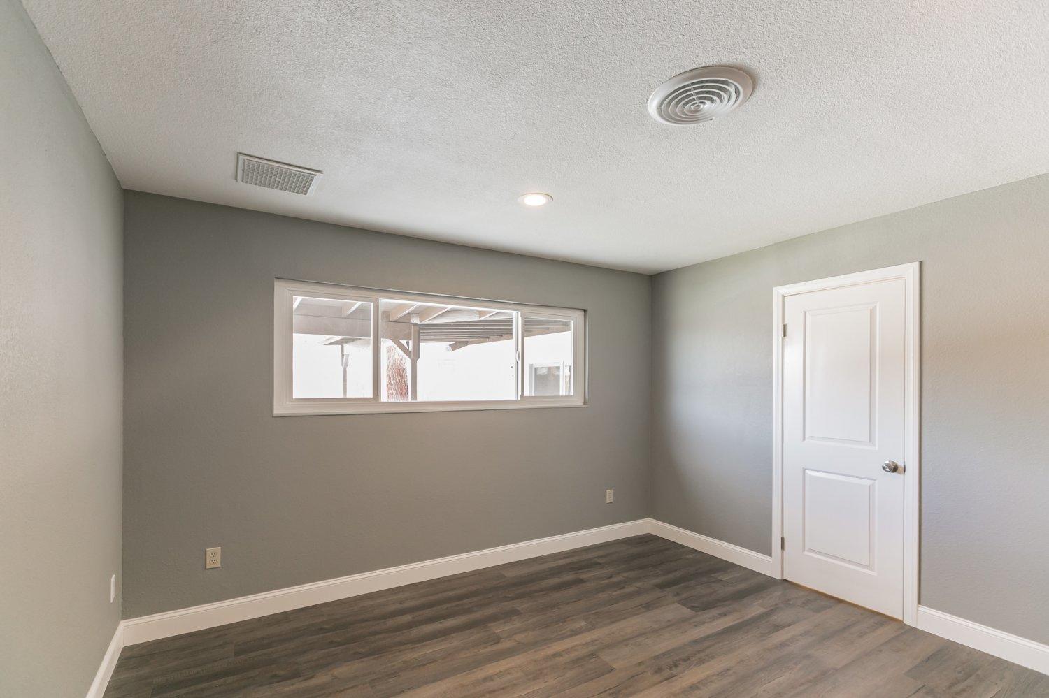 441 Debra Lane Ridgecrest, CA 93555 - Photo 21 of 30 an empty room with wooden floor and windows