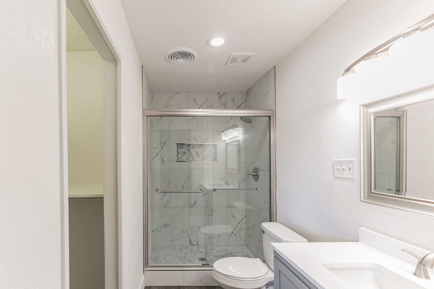 441 Debra Lane Ridgecrest, CA 93555 - Photo 24 of 30 a bathroom with a shower a toilet and a sink