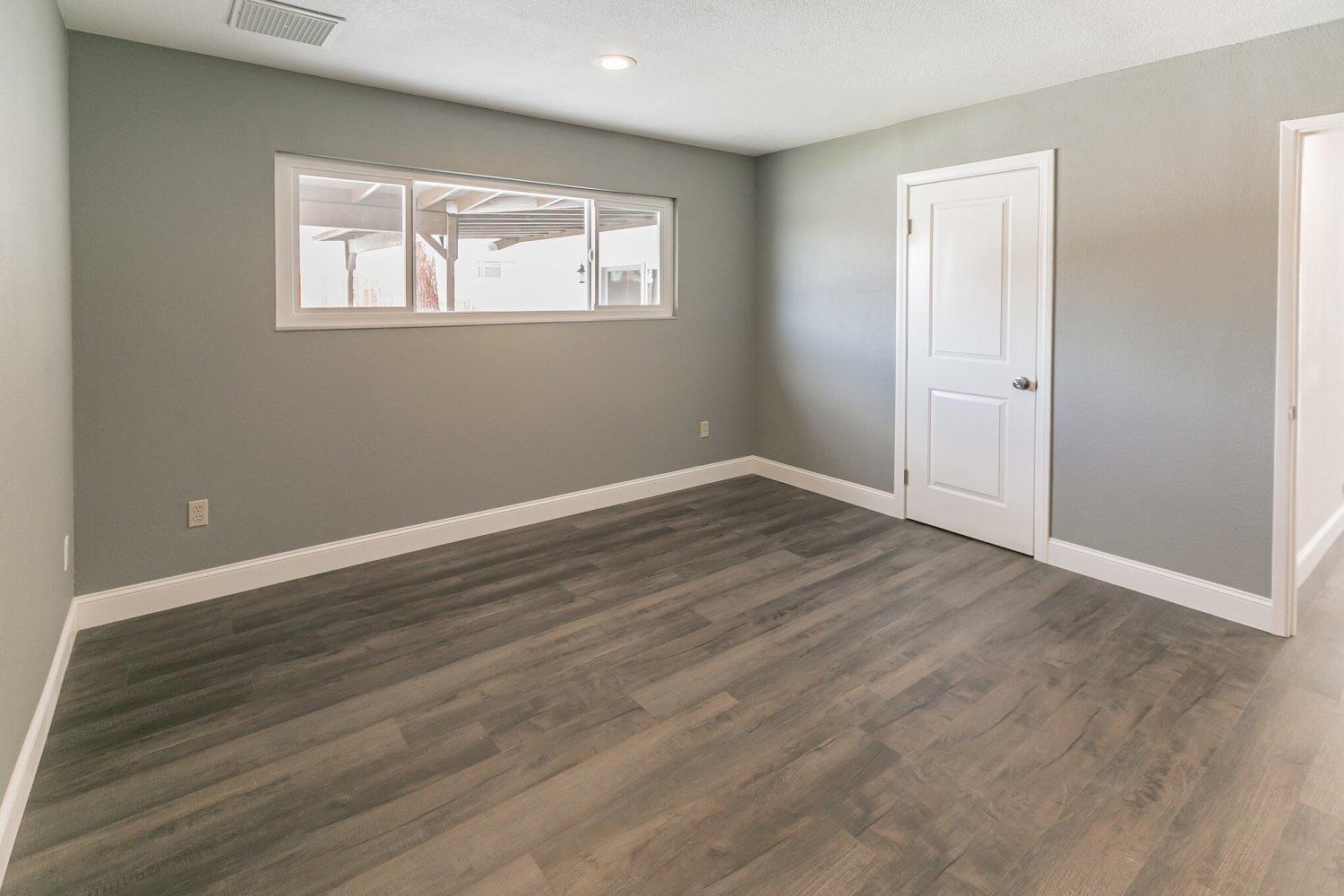 441 Debra Lane Ridgecrest, CA 93555 - Photo 27 of 30 an empty room with wooden floor and windows