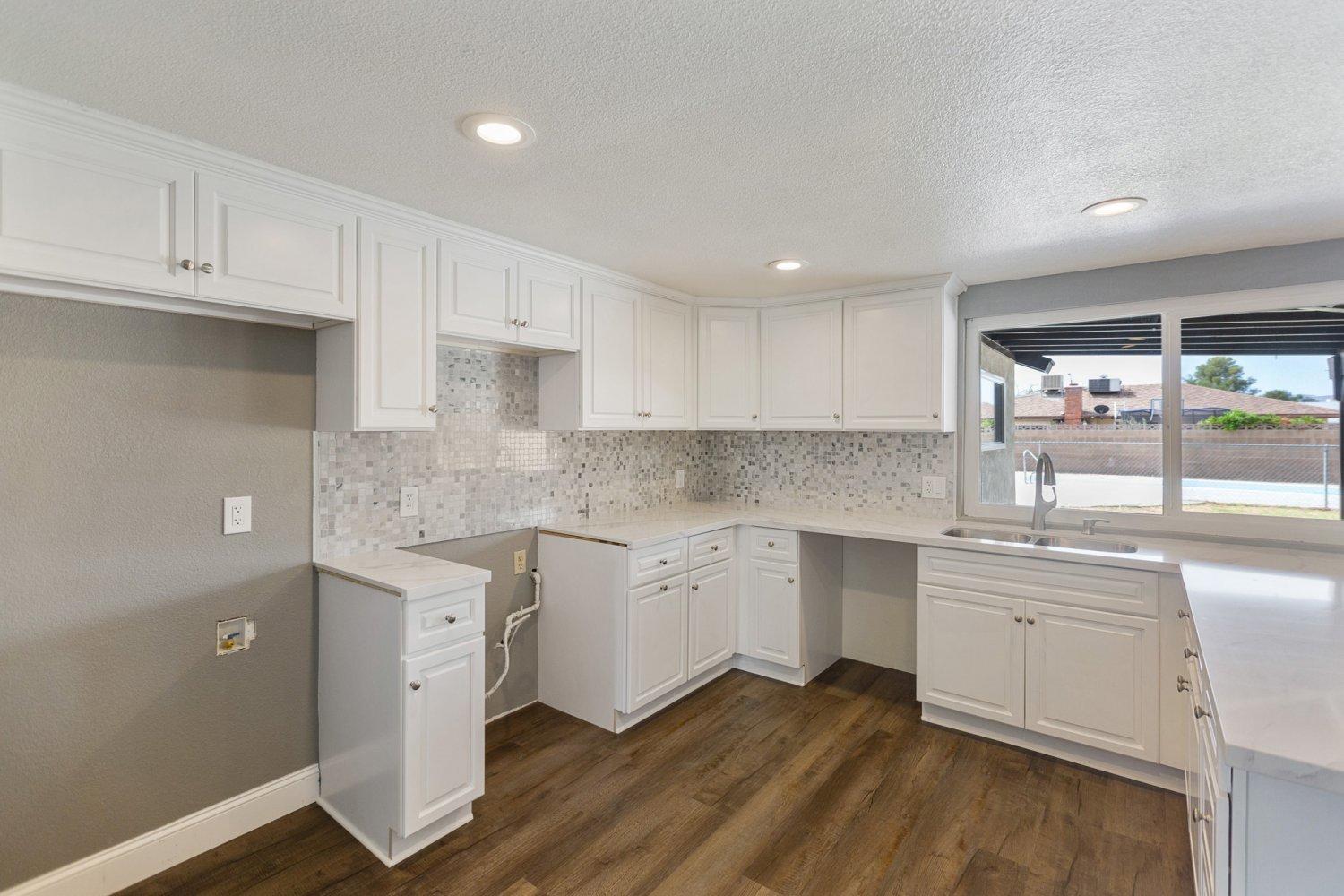 441 Debra Lane Ridgecrest, CA 93555 - Photo 30 of 30 a kitchen with sink cabinets and wooden floor